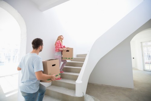Movers transporting household items through a South Kensington property